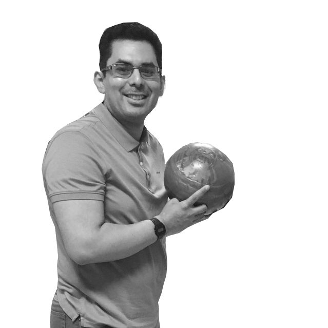 Man holding a bowling ball and smiling.