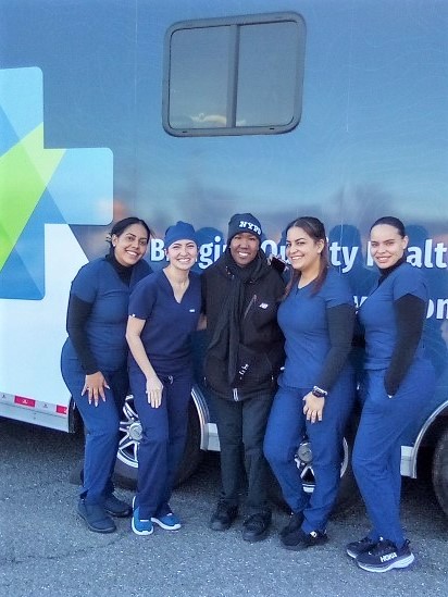 Group of people in front of mobil dental clinic