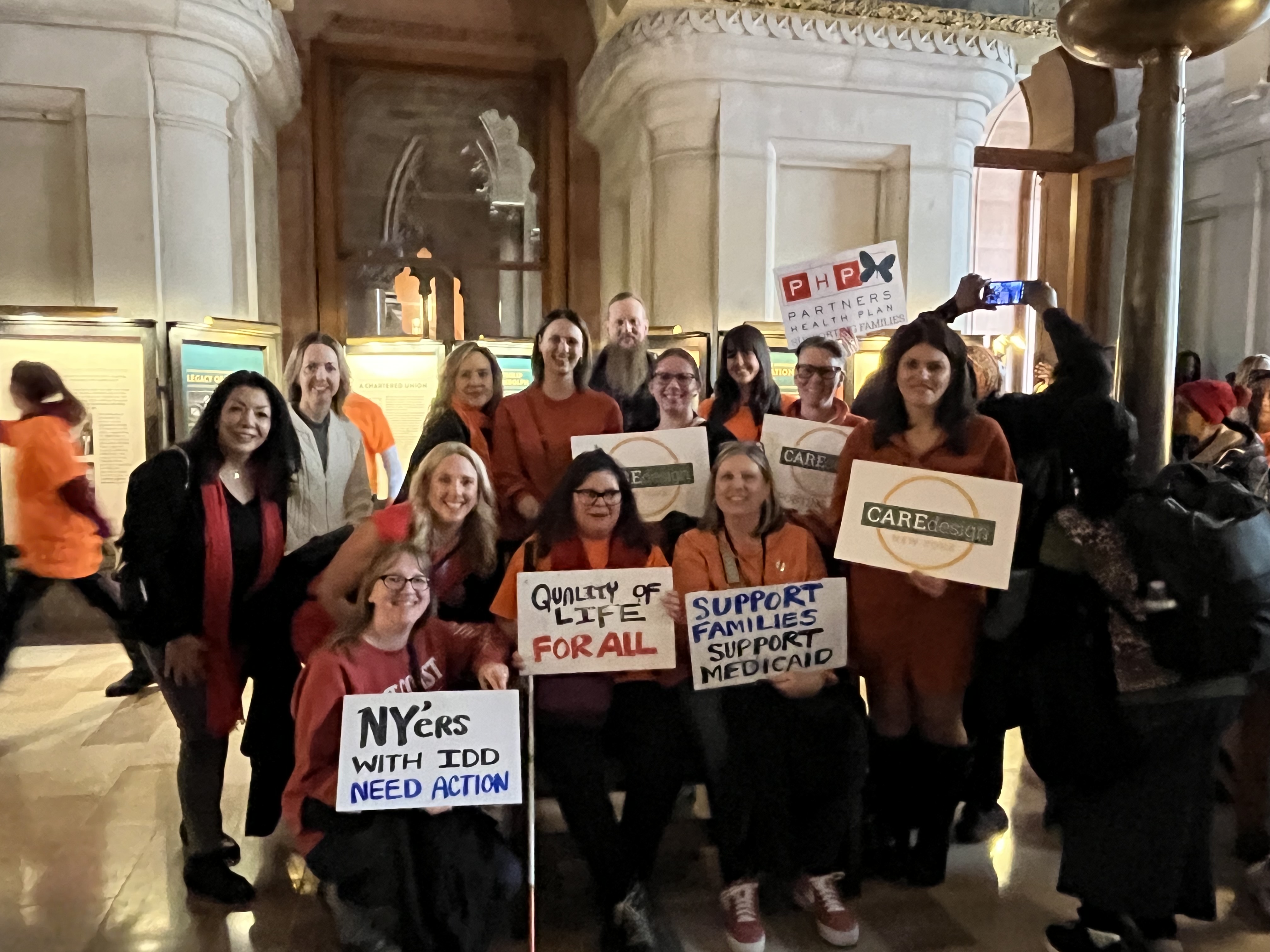 NYDA Rally event members standing holding signs