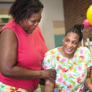 Member and caretaker embracing