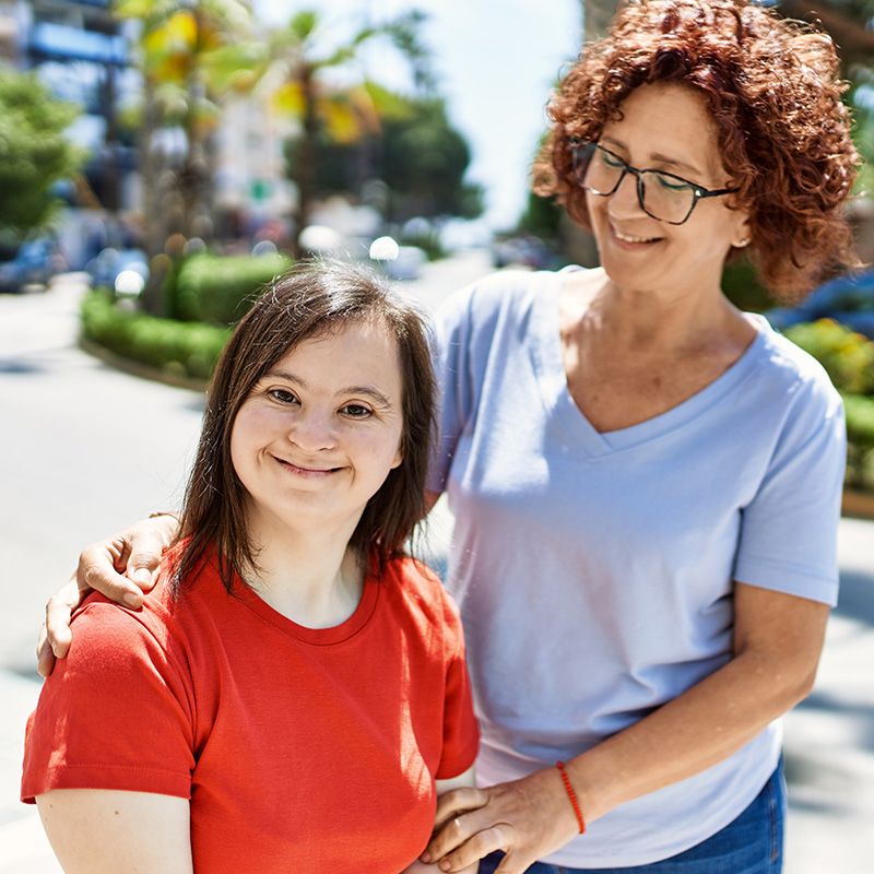 Woman with arm around another woman